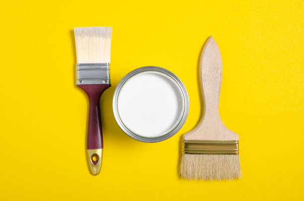 istock Open can with white paint and brush 1193312534