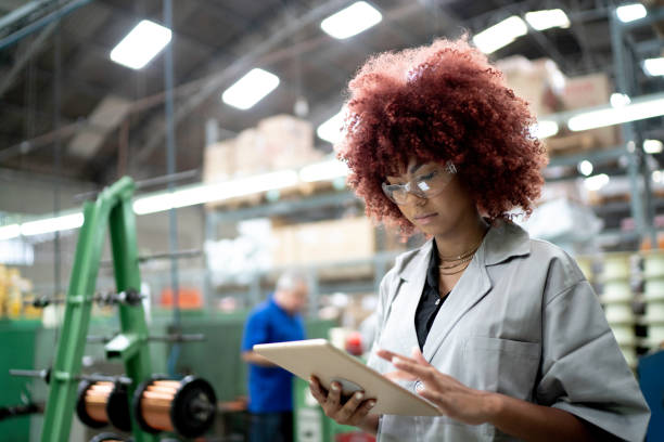 istock Technician using digital tablet while working in the production line of a factory 1193313324