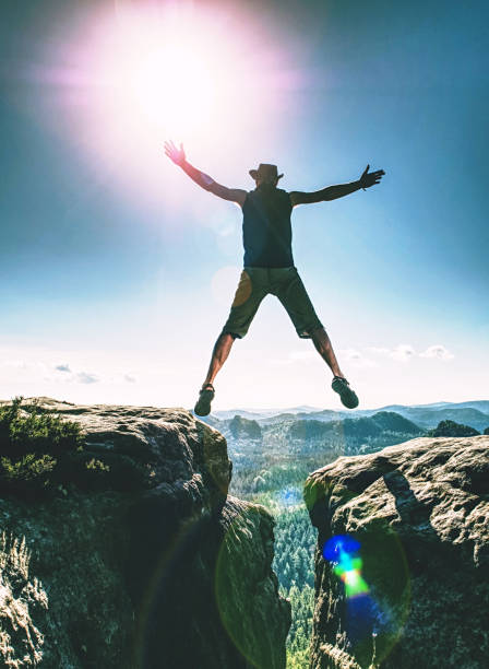 istock Personal challenge, risk and freedom. Crazy  man jumping over 1193314136