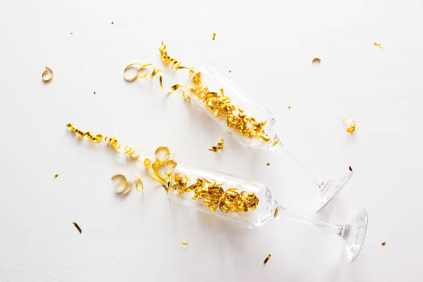 istock champagne glasses and confetti on a white background 1193314892