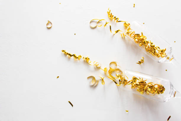 istock champagne glasses and confetti on a white background with place for text 1193314965