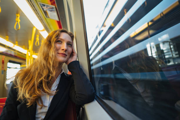 istock Businesswoman daydreaming in train 1193316265