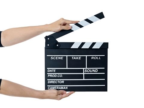 Woman hand holding a film slate on white background.