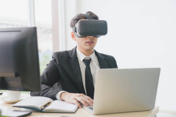 istock Asian young businessman using digital VR and smart phone with online game and text message on social network 1193319866