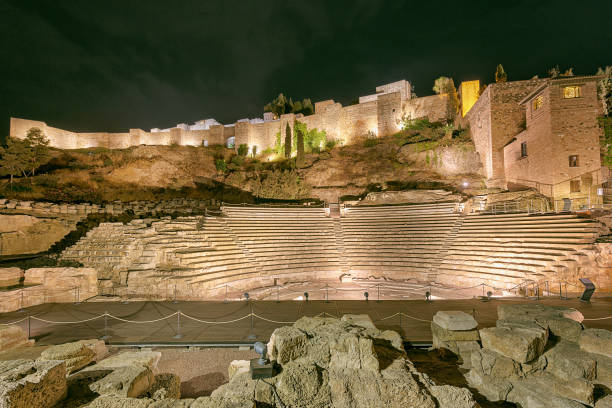 Roman theatre in Malaga, Spain at night Ruins of the Teatro Romano, on the west slope of the Alcazaba hill alcazaba of málaga stock pictures, royalty-free photos & images