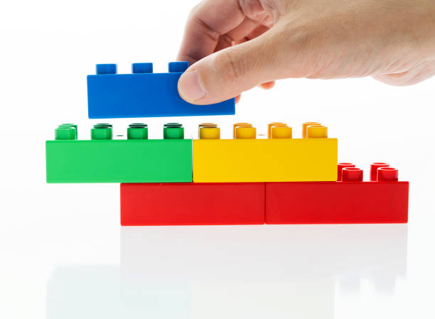 istock Human hand buildings toy bricks on white background 1193322398