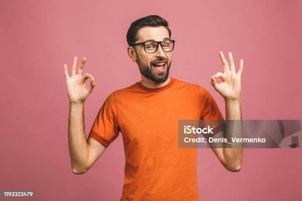 A Handsome Young Man In Casual Isolated On Pink Background Showing Ok Sign Stock Photo - Download Image Now