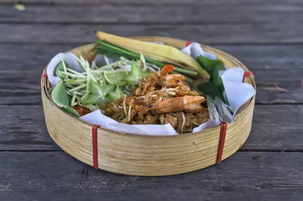 Photo of Pad thai with shrimp in handmade bamboo dished