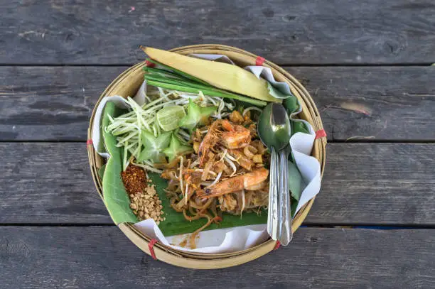 Photo of Pad thai with shrimp in handmade bamboo dished