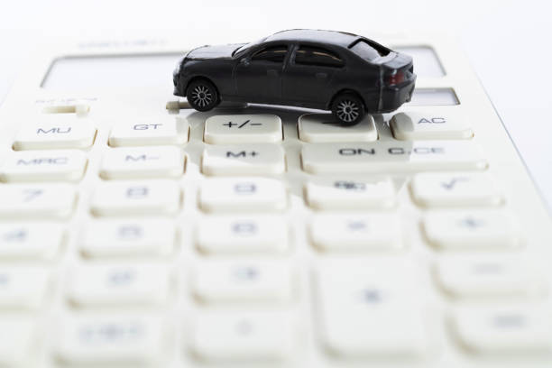 istock Calculator and toy car on white background 1193328542