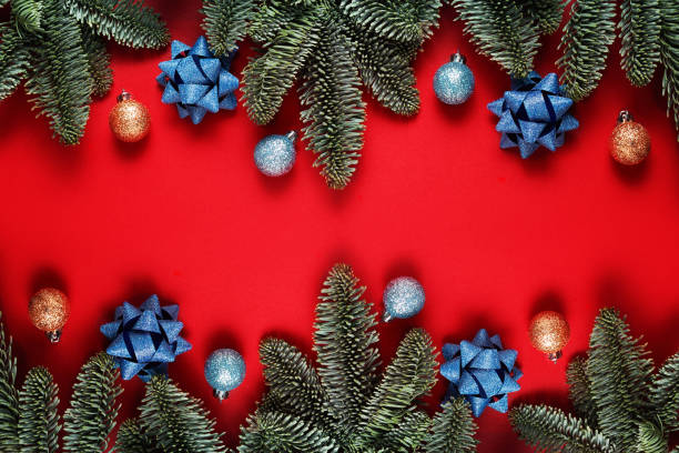 istock Christmas red background with christmas tree, balls and bow 1193328627