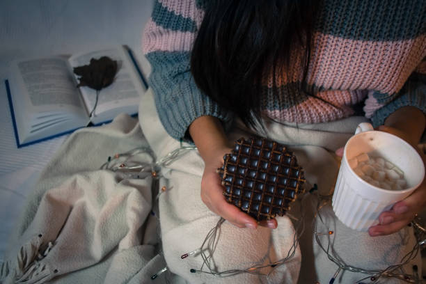 Girl drinks cocoa with marshmallow