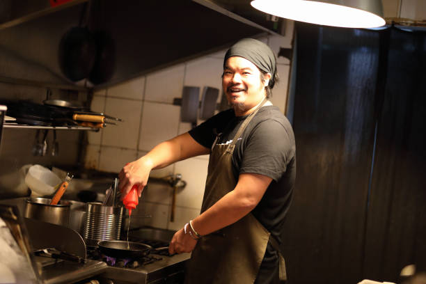 istock Chef preparing cuisine in kitchen portrait 1193331084
