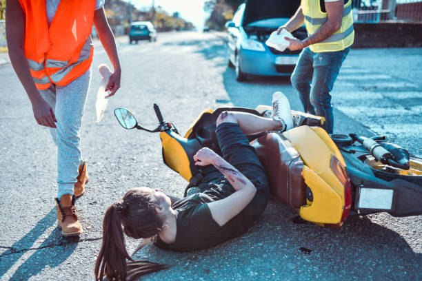 istock Ambulance Paramedics Rushing To Pull Female From Under Motorcycle 1193331673
