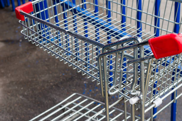 Close-up of empty Shopping carts left outdoors in a parking lot near a supermarket. Commercial equipment. Shooting from top to bottom at an angle. Without people. Selective focus. purchase of steel scrap stock pictures, royalty-free photos & images