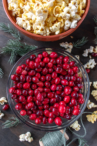 bowls of cranberries and popcorn for stringing Christmas garland top view