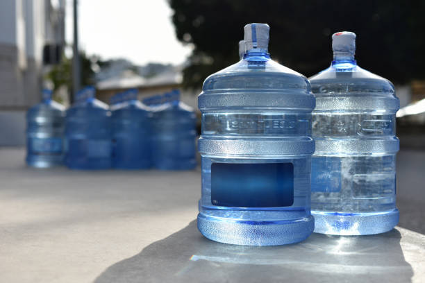 Plastic bottles of natural spring water Plastic bottles on 19 liters is full natural spring water in outdoor artesian water stock pictures, royalty-free photos & images