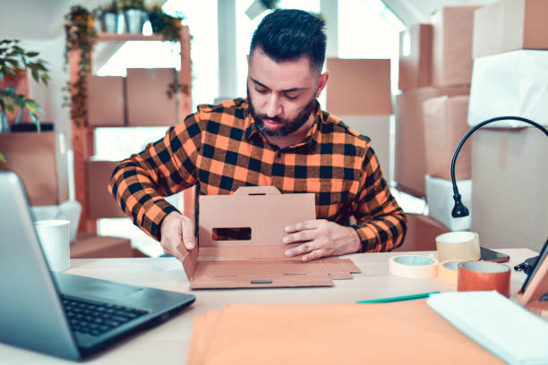 istock Male Delivery Office Worker Folding A Package 1193333279