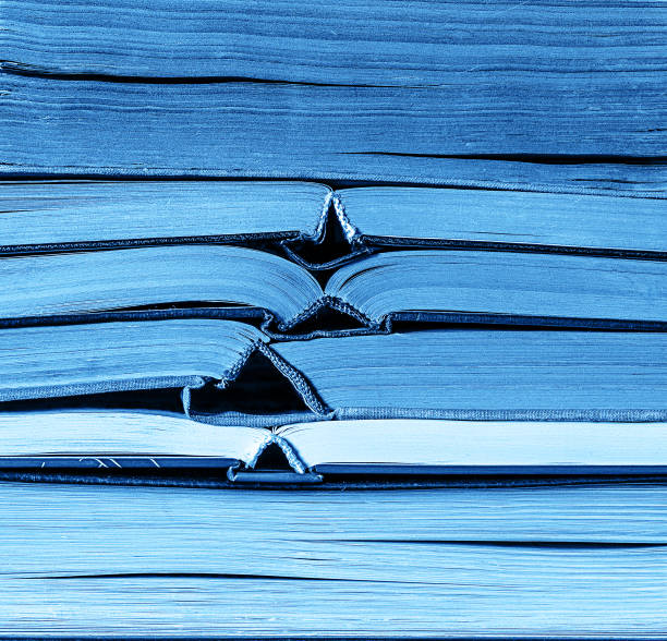 Classic blue color stack of old books background. Colour of the year 2020.