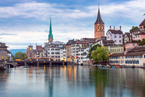 Zurich. View of the city embankment and the facades of old houses. View of the city embankment and the clock tower at sunset. Zurich. Switzerland. zurich photos stock pictures, royalty-free photos & images