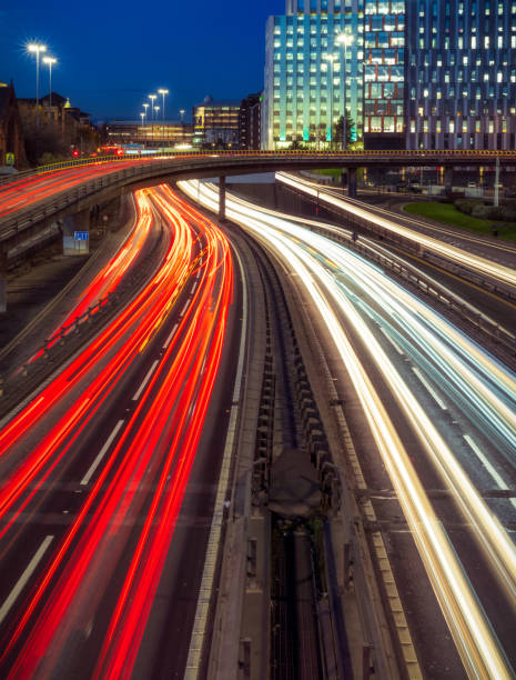 Rush hour traffic in Glasgow A long exposure image of rush hour traffic on the M8 motorway in Glasgow, Scotland. glasgow scotland stock pictures, royalty-free photos & images