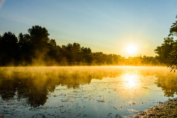 istock Fog above the water surface. Sunrise at river 1193335859