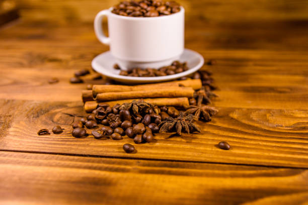 istock White cup filled with coffee beans, star anise and cinnamon sticks on wooden table 1193335862