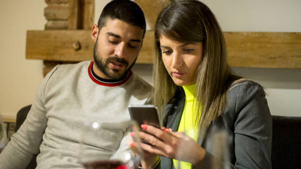 istock Happy couple checking something on mobile phone in cafe 1193336362