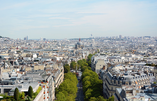 View down Avenue de Friedland from top of Arc de Triomphe, towards Saint-Augustin church. The Hertzienne communications tower stands 141 metres high on the outskirts of the city.