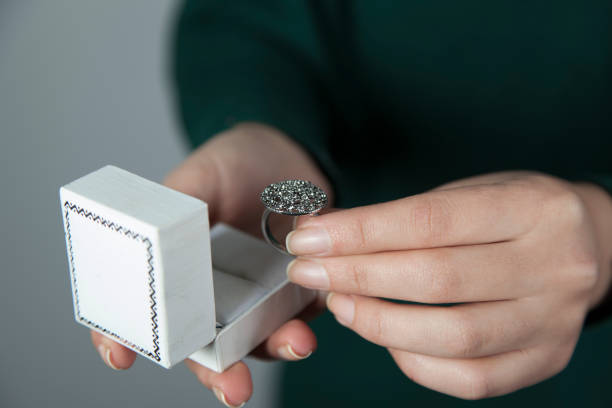 istock woman hand holding box with ring 1193341651