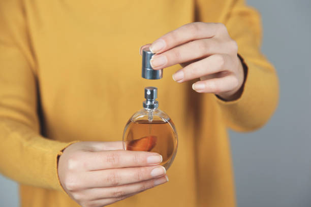 istock woman hand perfume bottle 1193341715