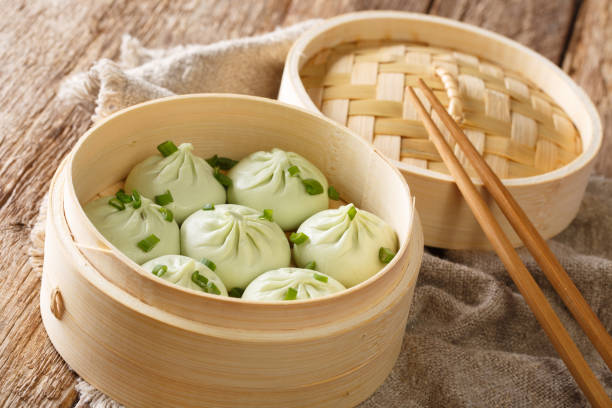 istock Bamboo steamer with tasty baozi dumplings closeup. horizontal 1193342071