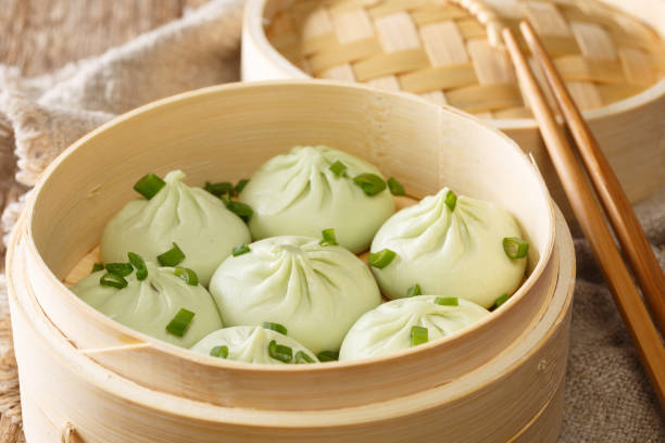istock Steamed baozi chinese buns in bamboo steamer closeup. horizontal 1193342395