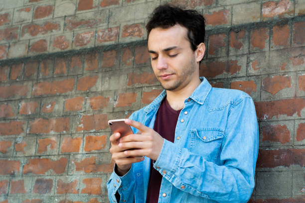 istock Young man typing on his phone. 1193346907