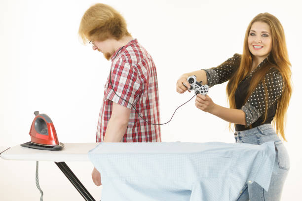 istock Woman controling man to do ironing 1193347124