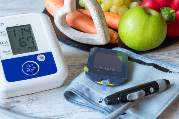 istock Devices for measuring blood pressure and blood glucose on a table with fruit and vegetables 1193348030