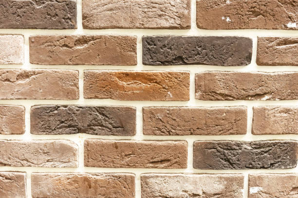 istock Brick wall of beige and brown bricks. Background and texture of brickwork. 1193349063