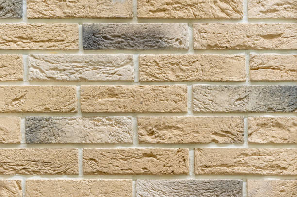 istock Brick wall of beige bricks. Background and texture of brickwork. 1193349086
