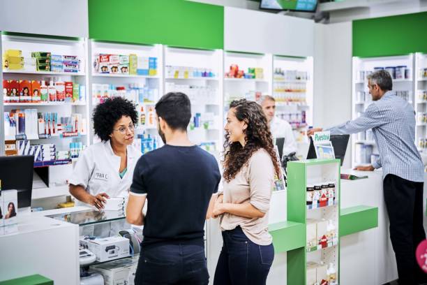 istock Customers discussing with chemist at drugstore 1193349952