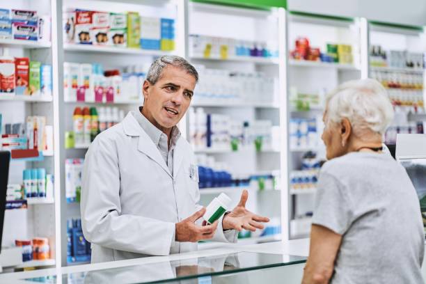 istock Chemist explaining medicine to senior customer 1193350023