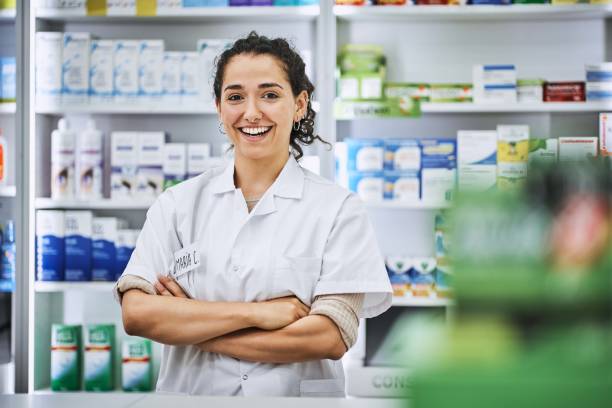 istock Smiling young female pharmacist with arms crossed 1193350078