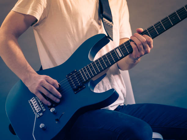 istock Male hands playing electric guitar 1193350130