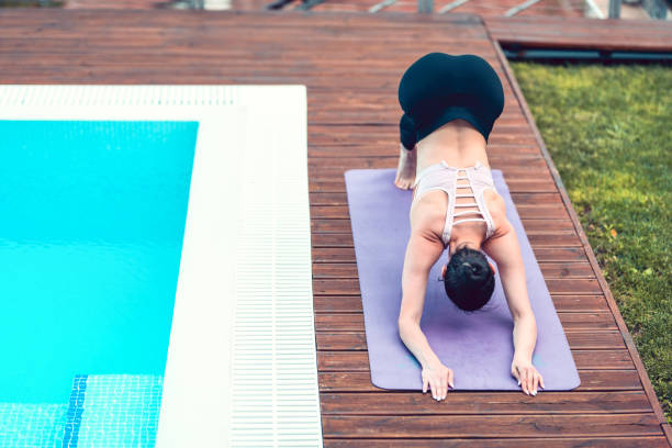 istock Female Yogini Showing Back Stretch Exercises 1193350914