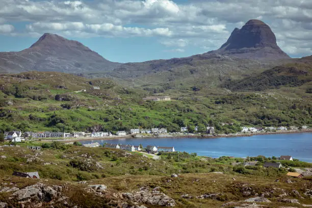 The busy port of Lochinver with the mountains of Canisp and Suilven in the background