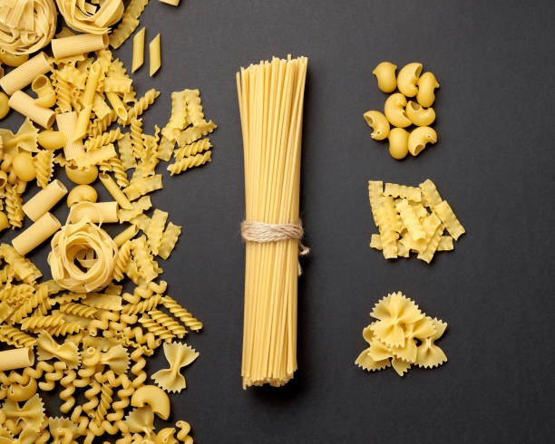 istock Assorted types of pasta on black background. Top view. Various forms of pasta. 1193353930
