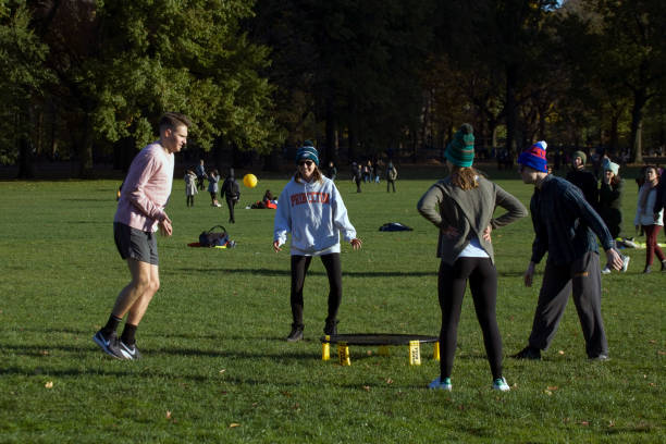 Group of Friends Play Spikeball Central Park NY stock photo