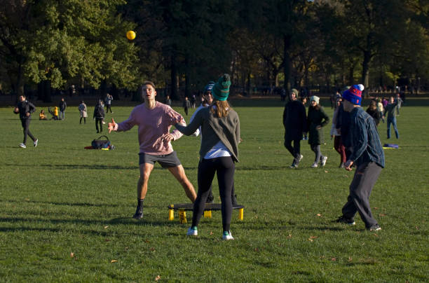 Group of Friends Play Spikeball Central Park NY stock photo