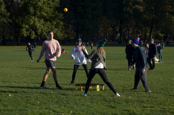 Group of Friends Play Spikeball Central Park NY stock photo