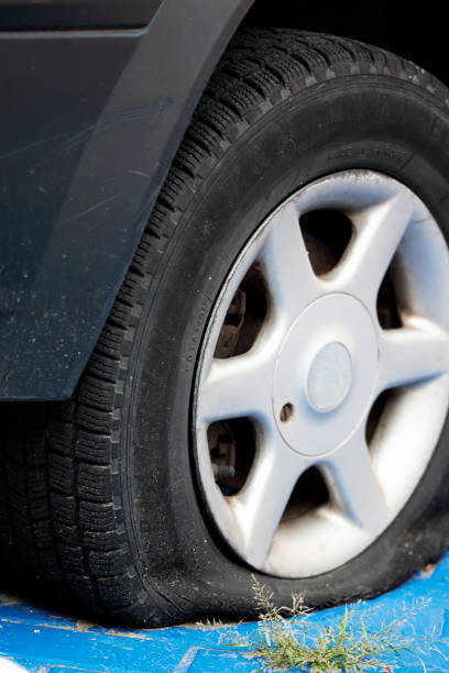 Old flat tire with rust wheel rim.