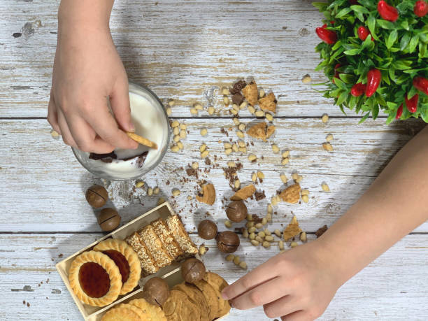 istock Children's hand with cookies. 1193358121